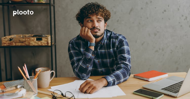 Business owner at desk with papers and laptop 