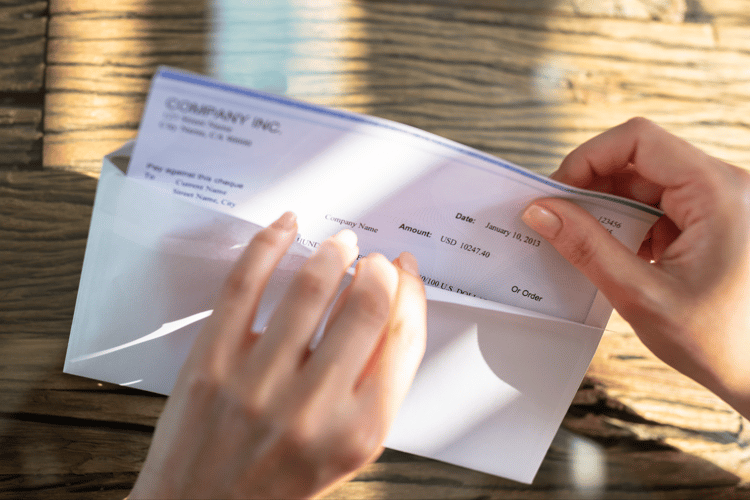 Person taking check out of an envelope