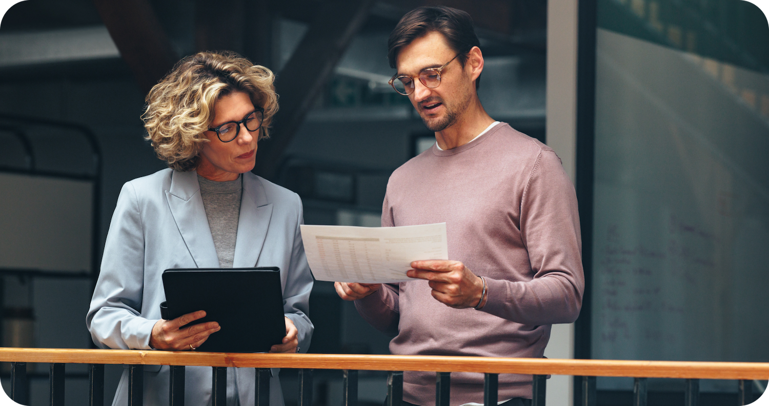 A man and woman review documentation together