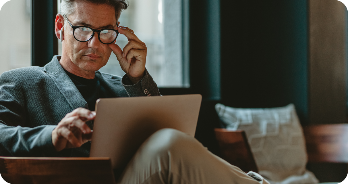 Guy sitting working on hit laptop